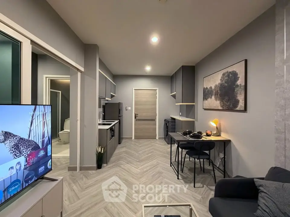 Modern open-layout kitchen and living area with sleek design and stylish decor