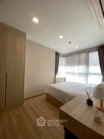 Modern bedroom with large windows and elegant wooden furniture