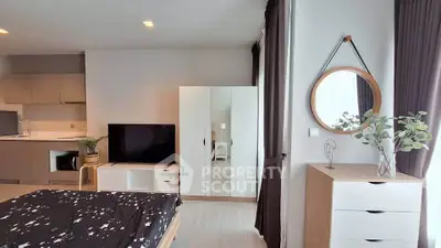 Modern studio apartment with stylish decor and open kitchen layout