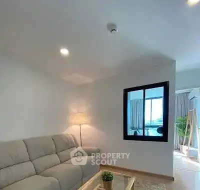 Modern living room with cozy sofa and bright natural light