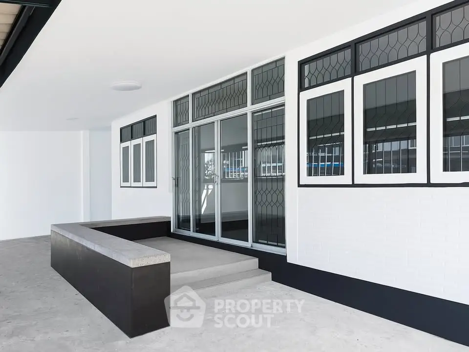 Modern building entrance with sleek glass windows and minimalist design.