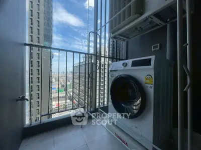High-rise apartment balcony with washing machine and city view