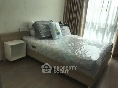 Modern bedroom with natural light and stylish decor in a cozy apartment.