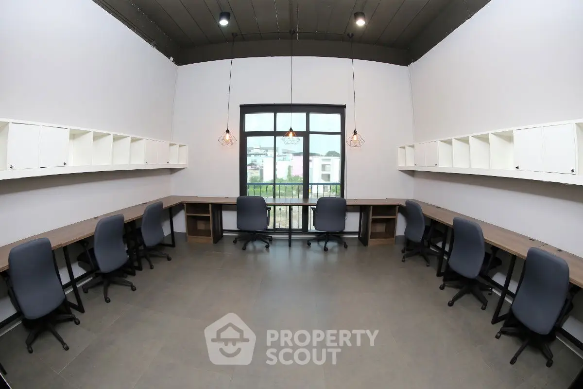 Modern study room with ample seating and natural light, ideal for collaborative workspaces.