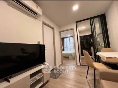 Modern apartment interior with cozy living area and bedroom view