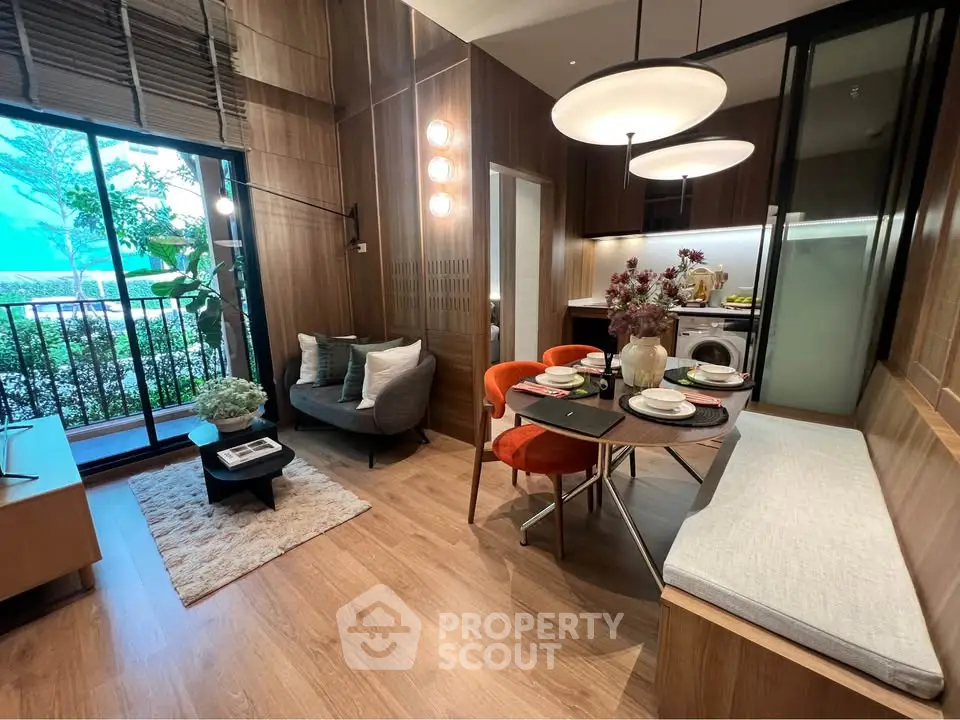 Modern living room with open kitchen, stylish decor, and balcony view in a contemporary apartment.