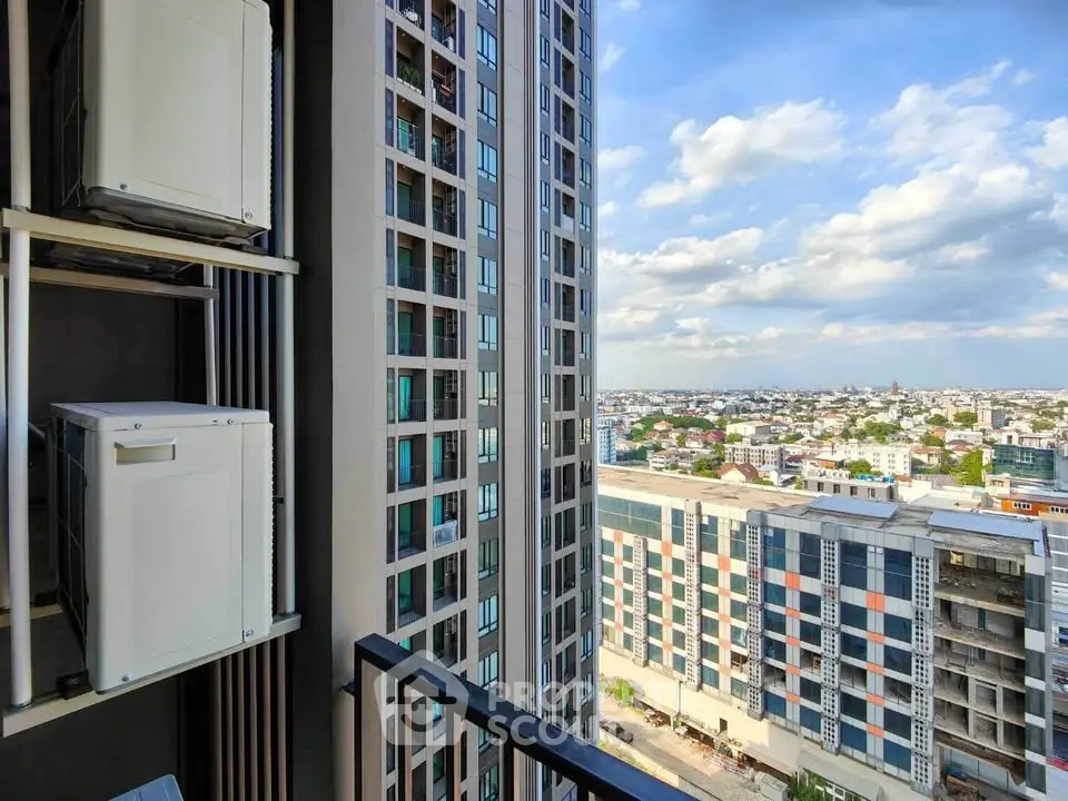 Stunning cityscape view from modern high-rise balcony with clear blue skies.