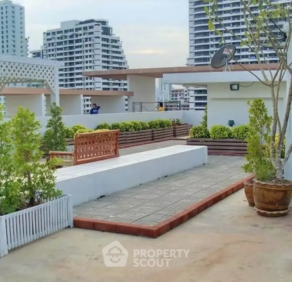 Stunning rooftop terrace with lush greenery and city skyline views, perfect for relaxation and entertainment.