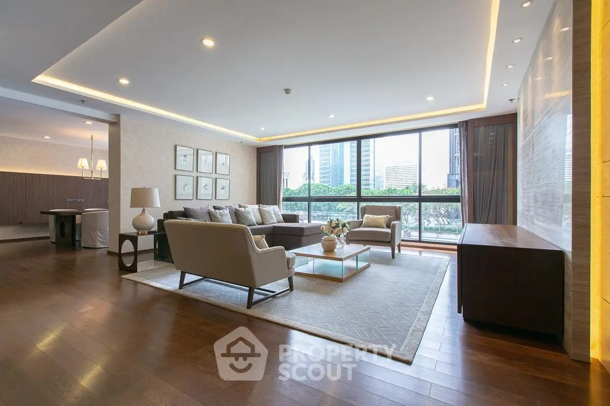 Luxurious living room with modern decor and stunning city view, featuring elegant furniture and large windows.