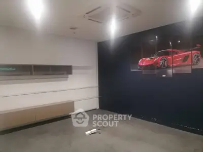 Modern interior space with sleek shelving and stylish car artwork on dark accent wall.