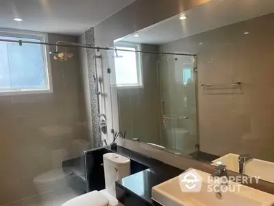 Modern bathroom with sleek fixtures and large mirror