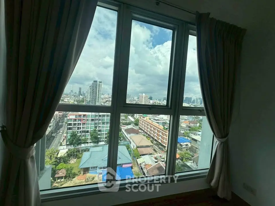 Stunning cityscape view from a high-rise apartment window, showcasing urban living at its finest.