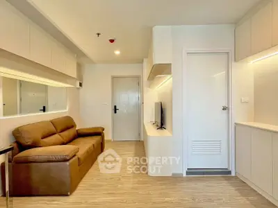 Modern living room with sleek design and comfortable brown sofa in a bright apartment.