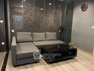 Modern living room with sleek gray sofa and stylish black coffee table