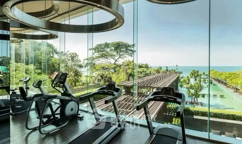 Luxurious gym with panoramic ocean view and modern equipment in a high-end property.