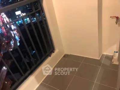 Cozy balcony with city view, perfect for relaxation and enjoying the night skyline.
