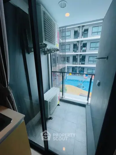 Charming balcony with pool view in modern apartment complex