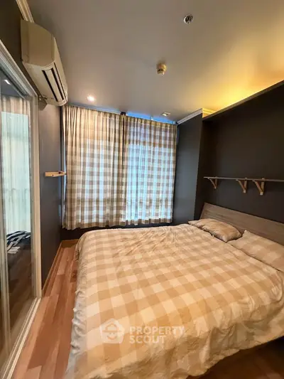 Cozy bedroom with modern decor and large window for natural light