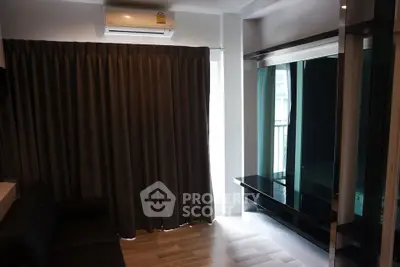 Modern living room with sleek design and large window, featuring air conditioning and stylish flooring.