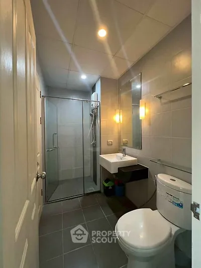 Modern bathroom with glass shower and sleek fixtures