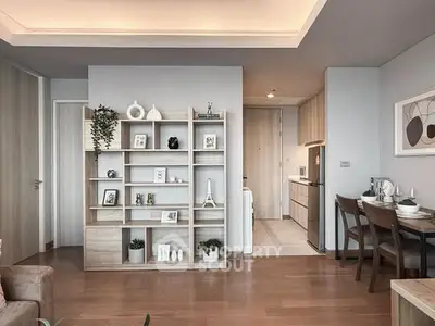 Modern open-plan living room with stylish shelving and dining area in a contemporary apartment.