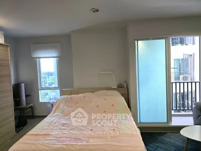 Cozy bedroom with balcony access and modern decor