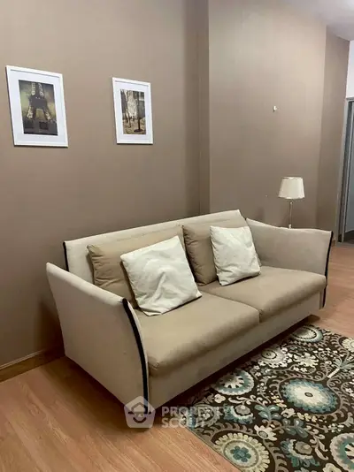 Cozy living room with beige sofa and decorative rug