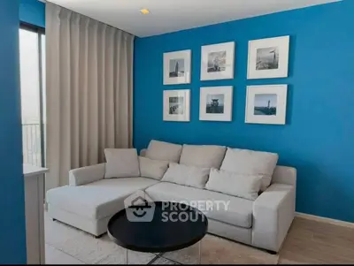 Modern living room with blue accent wall and cozy white sofa