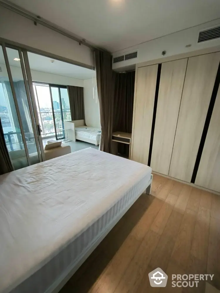 Modern bedroom with balcony view and ample natural light