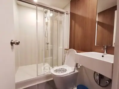 Modern bathroom with glass shower enclosure and sleek fixtures