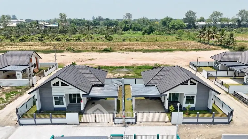 Modern twin houses with sleek design and spacious yards in a serene suburban area.