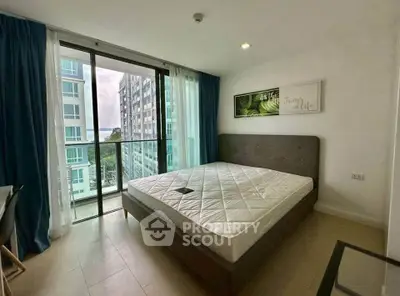 Modern bedroom with large windows and balcony view in a high-rise apartment.