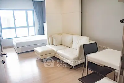 Modern studio apartment with cozy living area and natural light