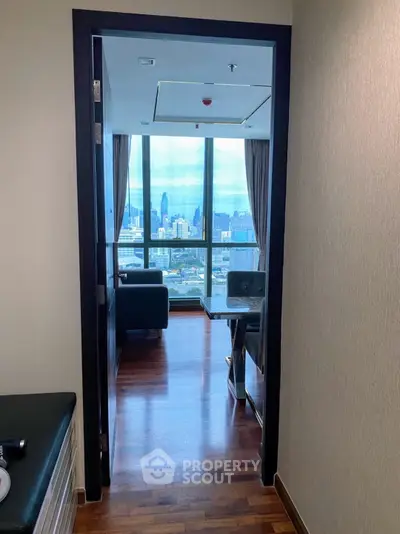 Modern apartment with stunning city view through large windows and elegant interior design.