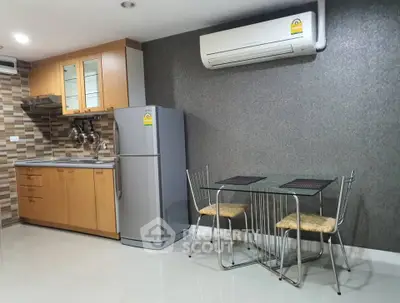 Modern kitchen with sleek appliances and dining area in stylish apartment