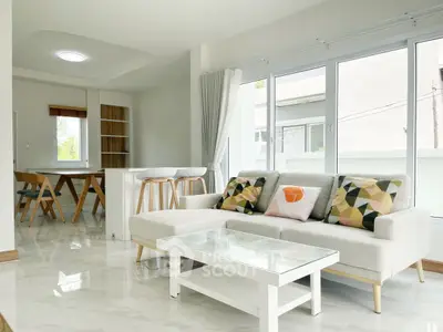 Bright modern living room with stylish decor and large windows