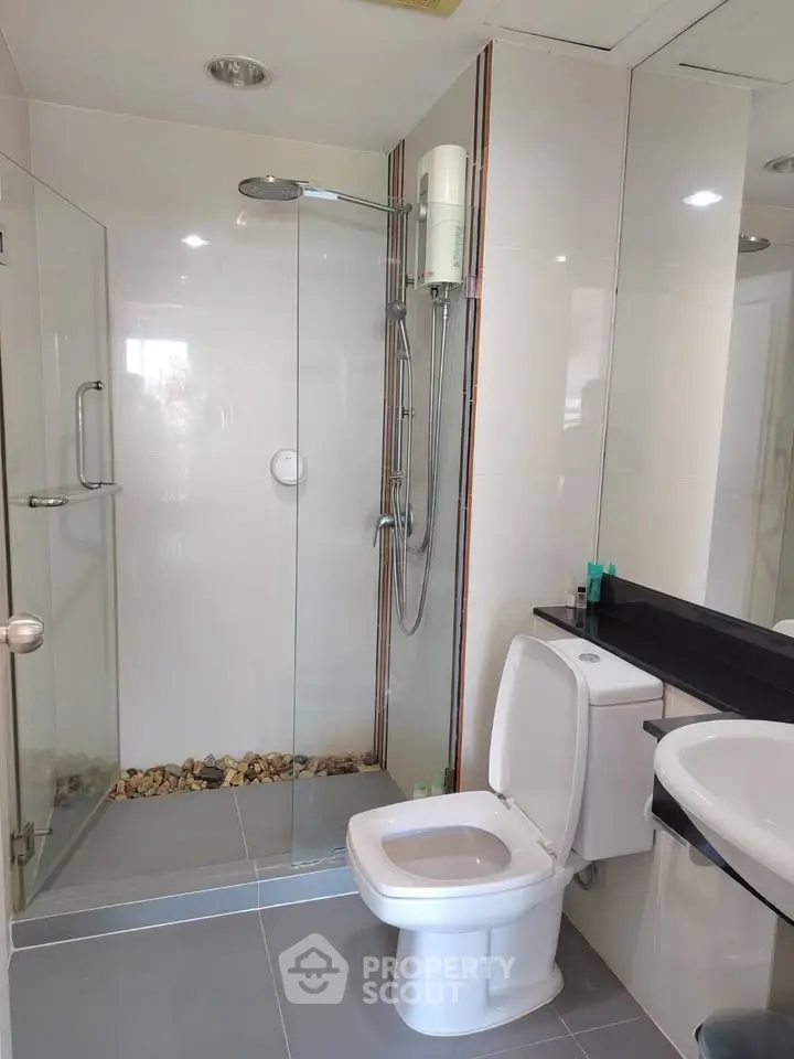 Modern bathroom with glass shower and sleek fixtures