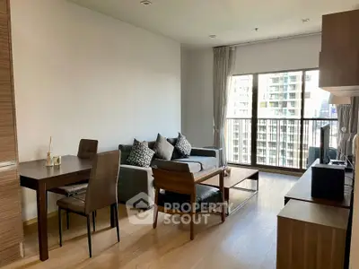 Modern living room with stylish furniture and city view from large windows.