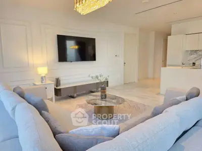 Luxurious modern living room with elegant decor and large flat-screen TV