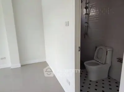 Minimalist bathroom with modern fixtures and white tiled walls