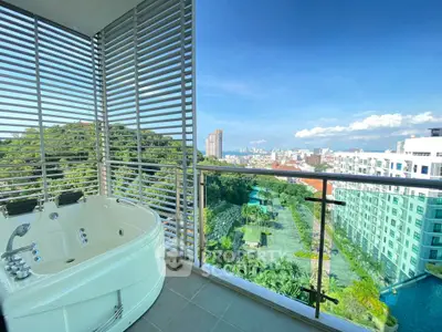 Luxurious balcony with jacuzzi and stunning city view in modern high-rise apartment.