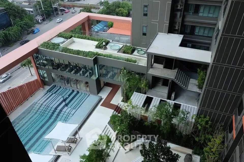 Luxurious condominium with rooftop pool and lush greenery in urban setting