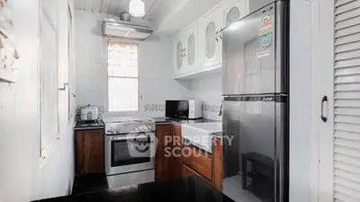 Charming kitchen with modern appliances and sleek design in cozy apartment.