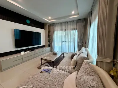 Modern living room with stylish decor and large TV, featuring cozy seating and elegant curtains.