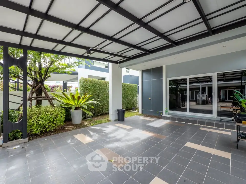 Spacious modern patio with sleek design and lush greenery, perfect for outdoor relaxation and entertainment.