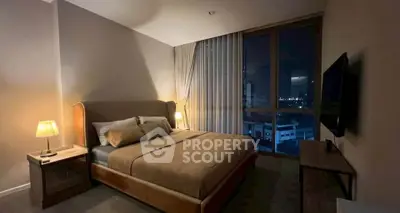 Luxurious bedroom with city view, featuring elegant lighting and modern decor.