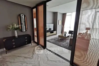 Modern living room with elegant decor and marble flooring, featuring a cozy seating area and stylish furniture.