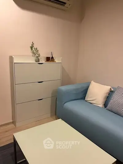 Cozy living room with blue sofa and modern storage cabinet