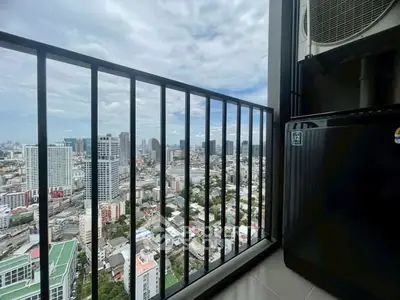 Stunning high-rise balcony view of city skyline with modern air conditioning unit.