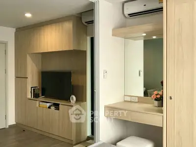 Modern bedroom with built-in wooden furniture and wall-mounted TV